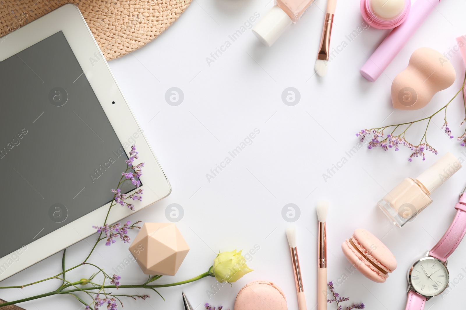 Photo of Frame made with tablet and beauty blogger's accessories on white background, top view