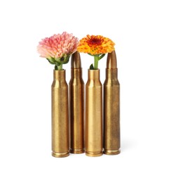 Photo of Bullets and cartridge cases with beautiful flowers isolated on white
