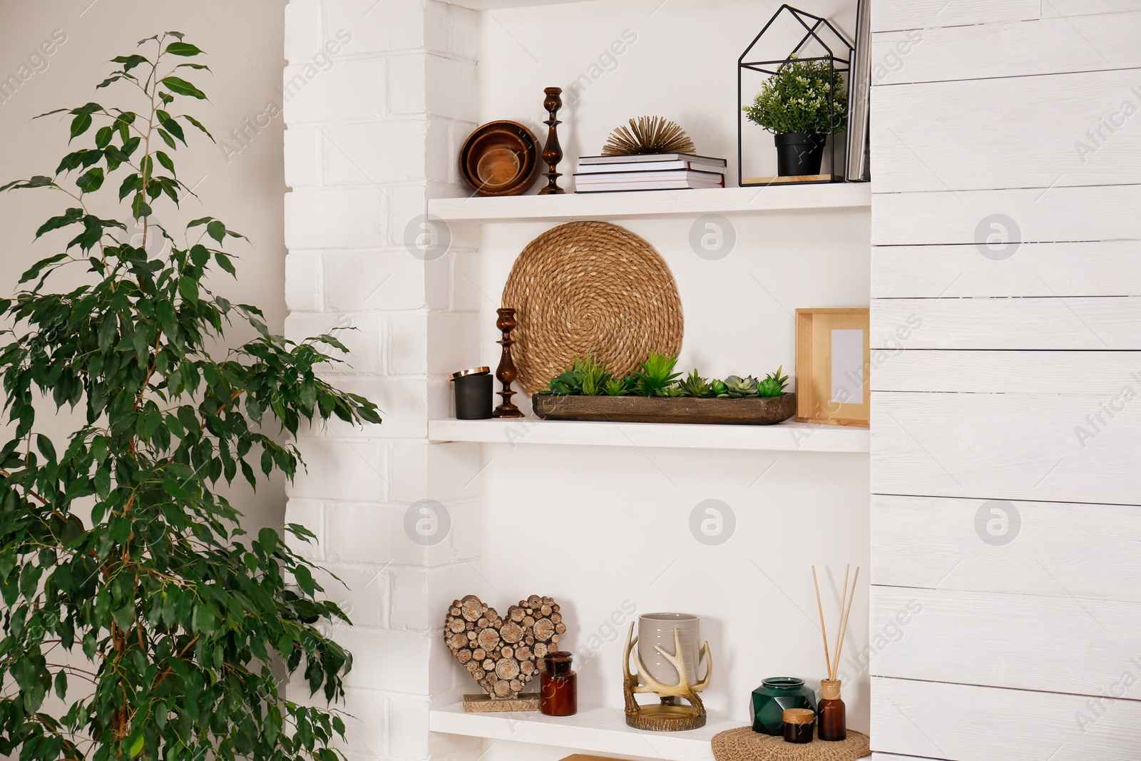 Photo of Wall shelves with beautiful decor elements indoors. Interior design