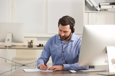 Hotline operator with headset working in office, space for text