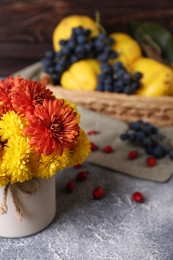 Photo of Bouquet of beautiful chrysanthemum flowers on grey table. Space for text