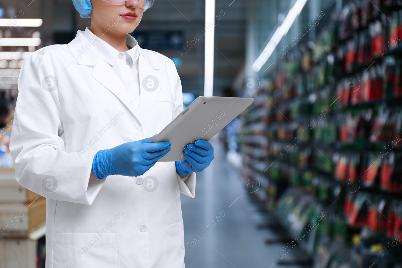 Image of Food quality control specialist examining products in supermarket, closeup