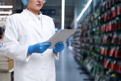 Food quality control specialist examining products in supermarket, closeup