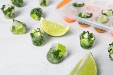 Photo of Composition with lime and mint ice cubes on light background