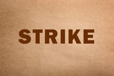 Protest concept. Word Strike on kraft paper