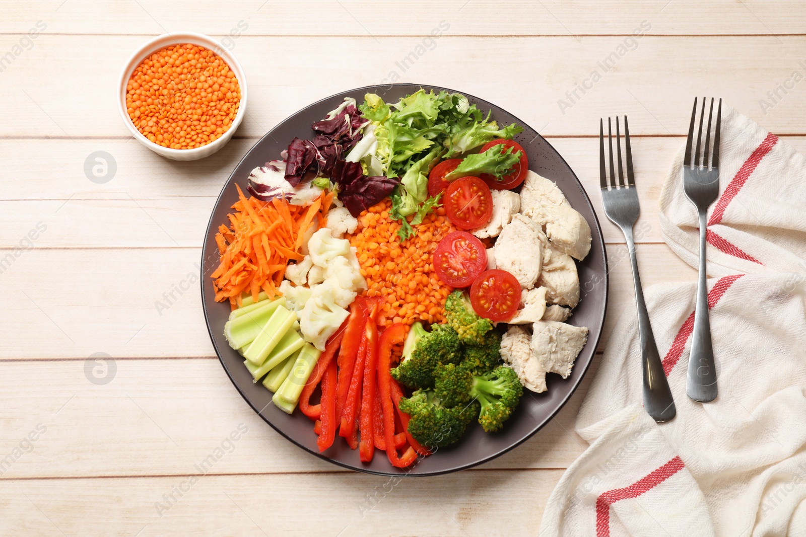 Photo of Balanced diet and healthy foods. Plate with different delicious products served on light wooden table, top view