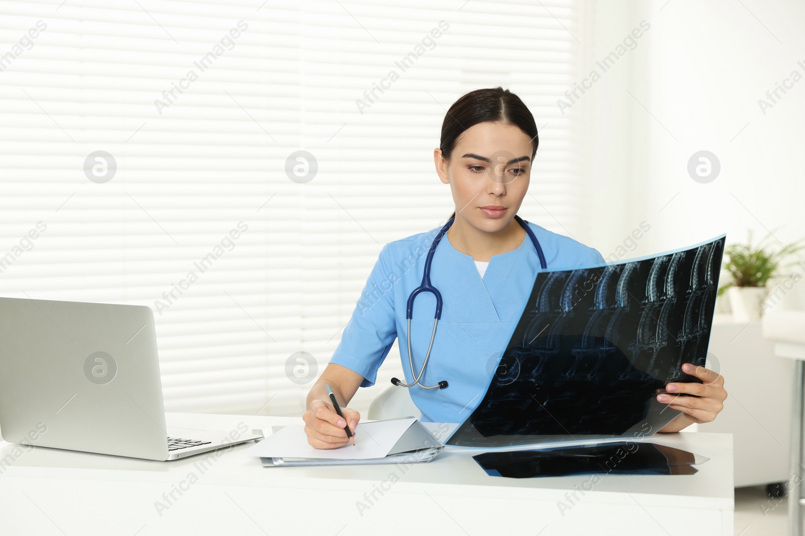 Photo of Doctor examining neck MRI image in clinic