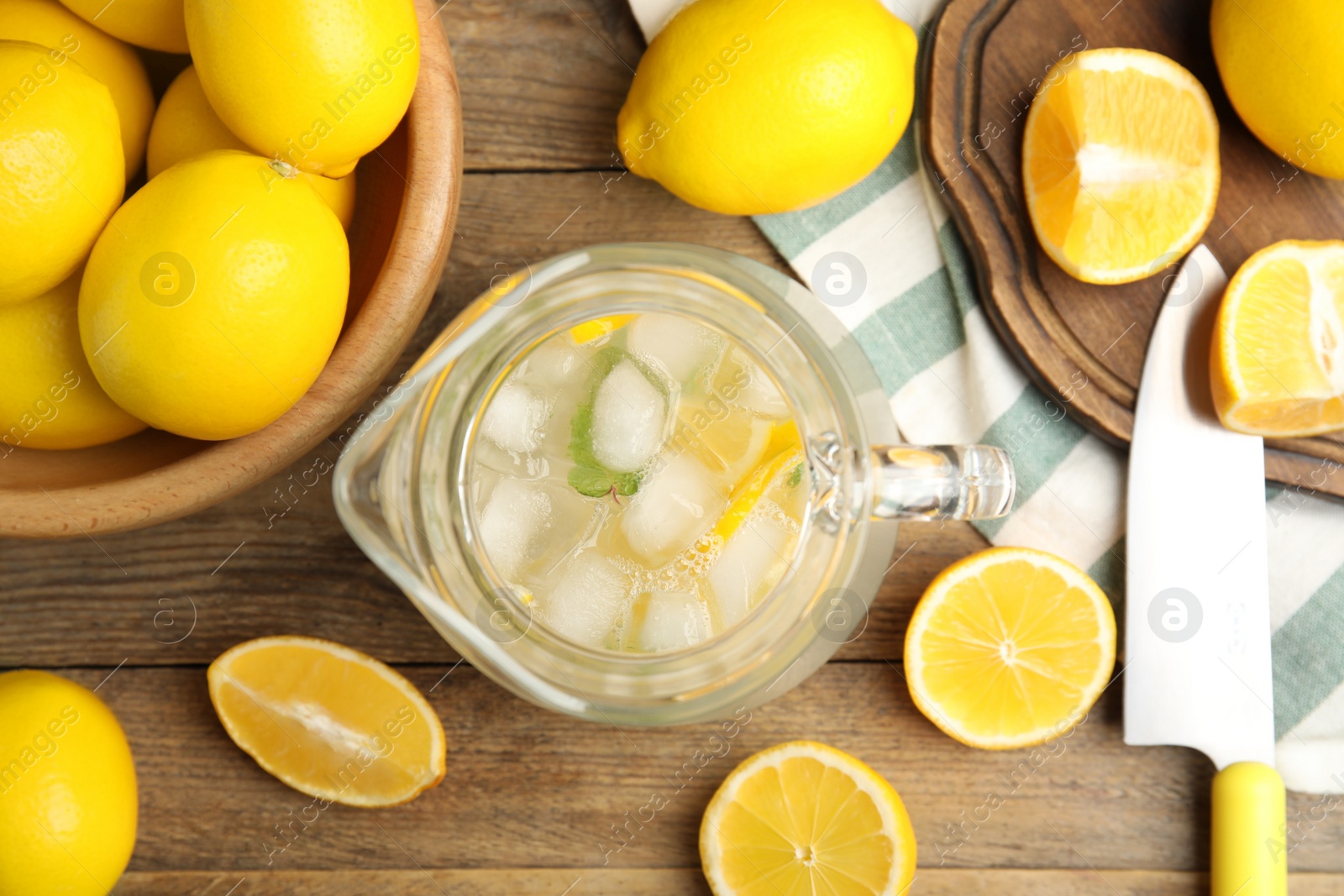 Photo of Cool freshly made lemonade and fruits on wooden table, flat lay