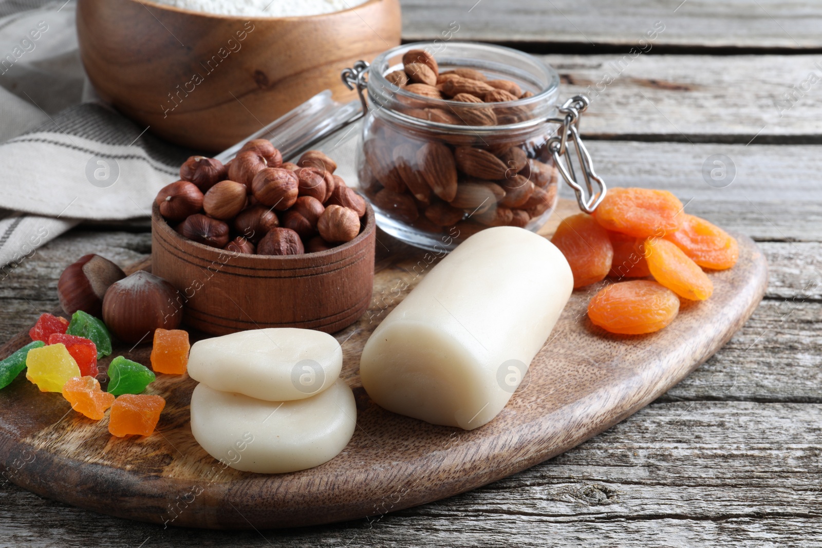 Photo of Marzipan and other ingredients for homemade Stollen on wooden table. Baking traditional German Christmas bread