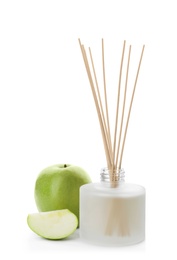 Aromatic reed freshener and apple on white background