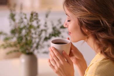 Photo of Beautiful young woman enjoying coffee at home. Weekend morning