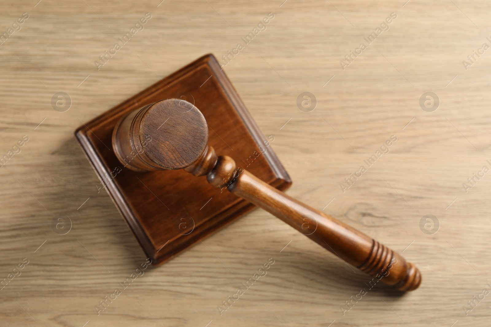 Photo of Wooden gavel and sound block on table, top view