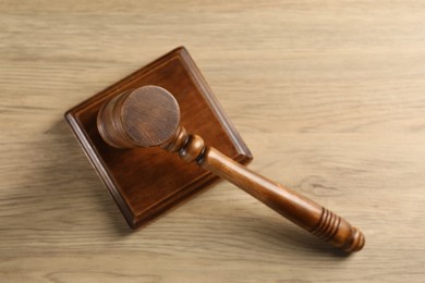 Wooden gavel and sound block on table, top view