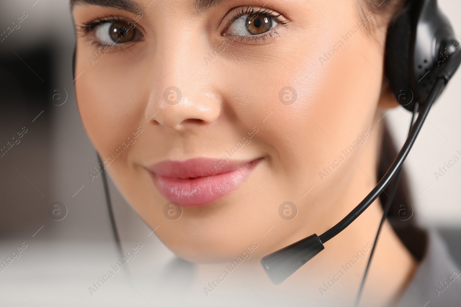 Photo of Hotline operator with headset working in office, closeup