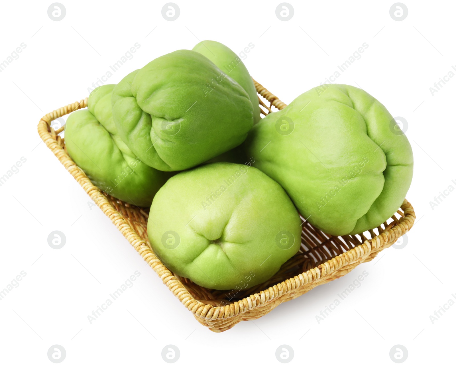 Photo of Fresh green chayote in wicker basket isolated on white