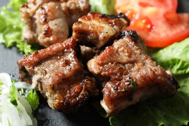 Tasty shish kebab served on slate plate, closeup