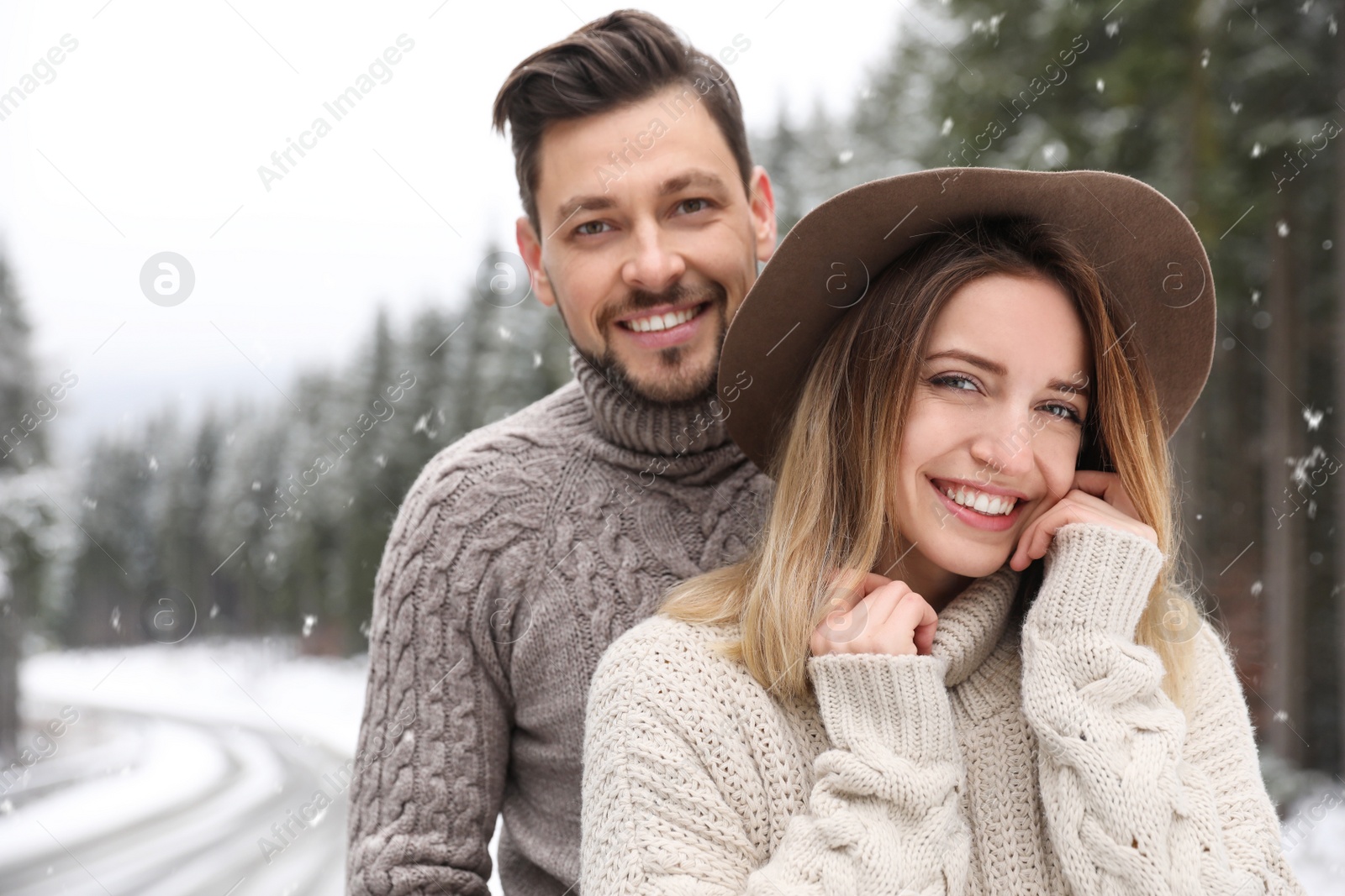 Photo of Cute couple outdoors on snowy day. Winter vacation