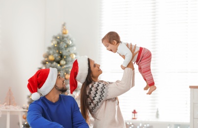 Happy family with cute baby at home. Christmas celebration