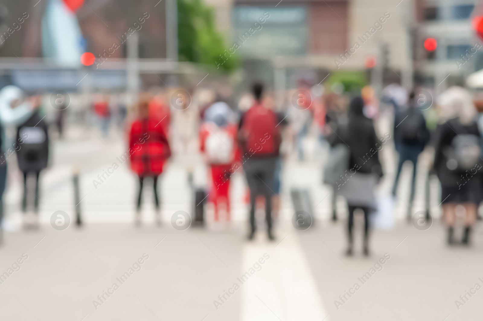 Photo of People waiting to cross street in city, blurred view