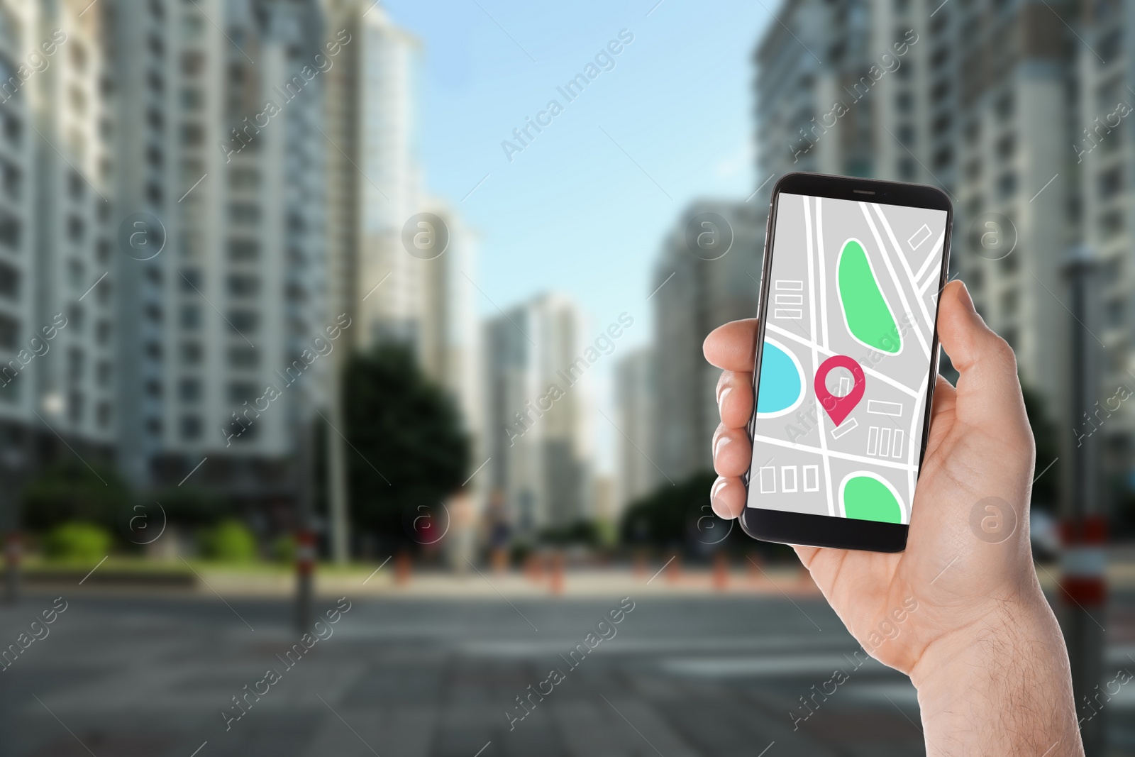 Image of Man searching location with smartphone in city, closeup. Space for text 