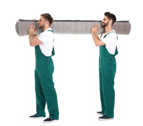 Young workers carrying rolled carpet isolated on white. Moving service