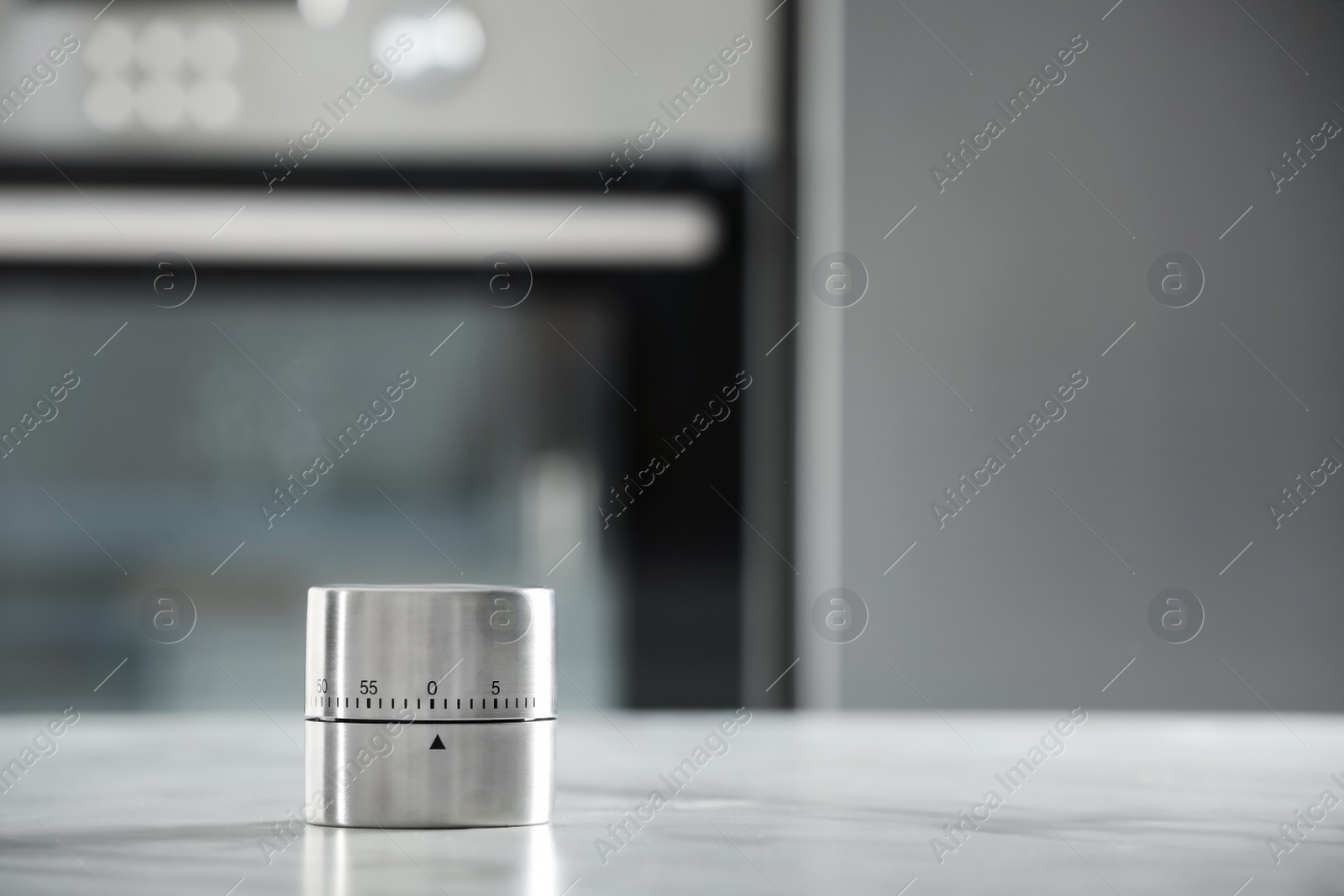 Photo of Kitchen timer on light grey table indoors. Space for text