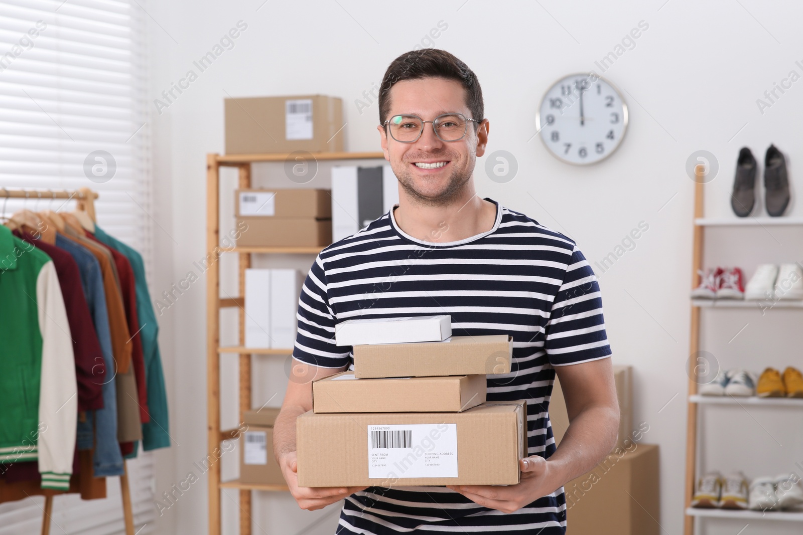 Photo of Seller with parcels in office. Online store