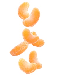Image of Fresh ripe tangerine pieces falling on white background