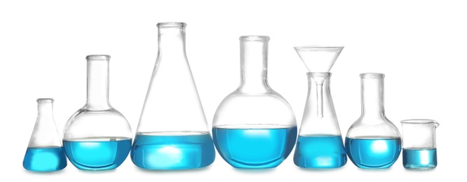Photo of Laboratory glassware with liquid on white background. Solution chemistry