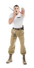 Male security guard using portable radio transmitter on white background