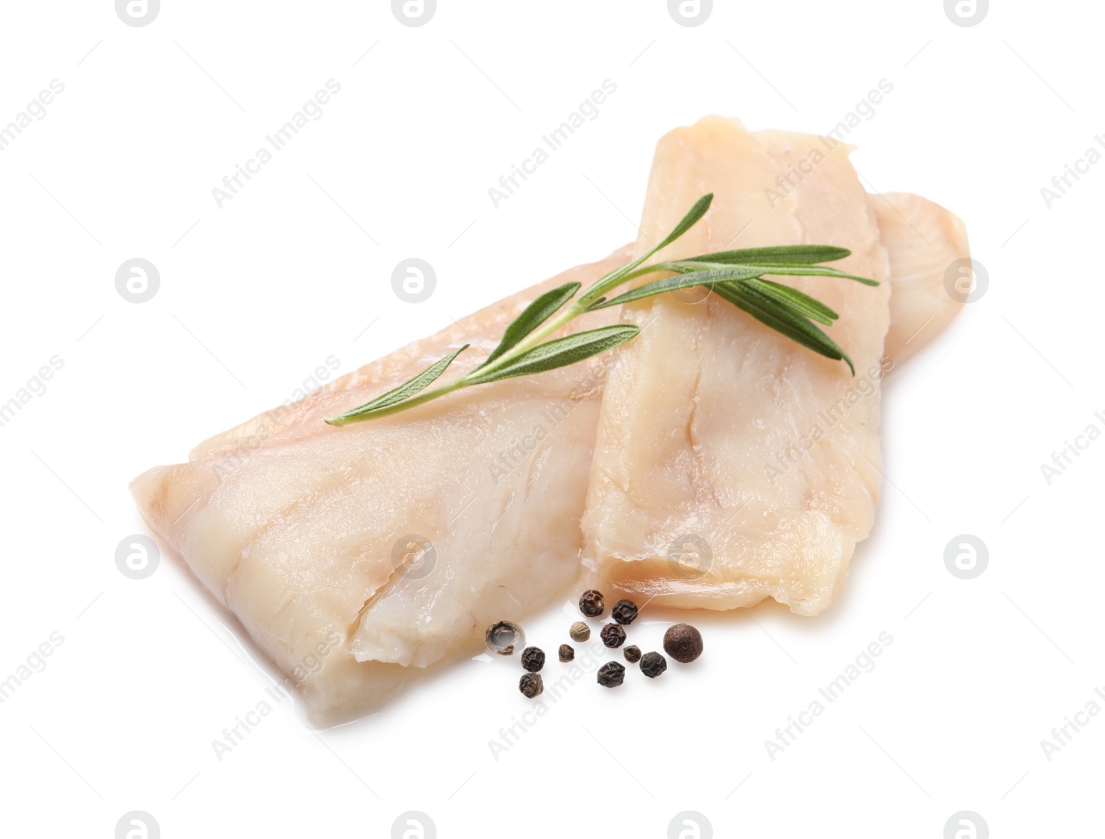 Photo of Pieces of raw cod fish, rosemary and peppercorns isolated on white