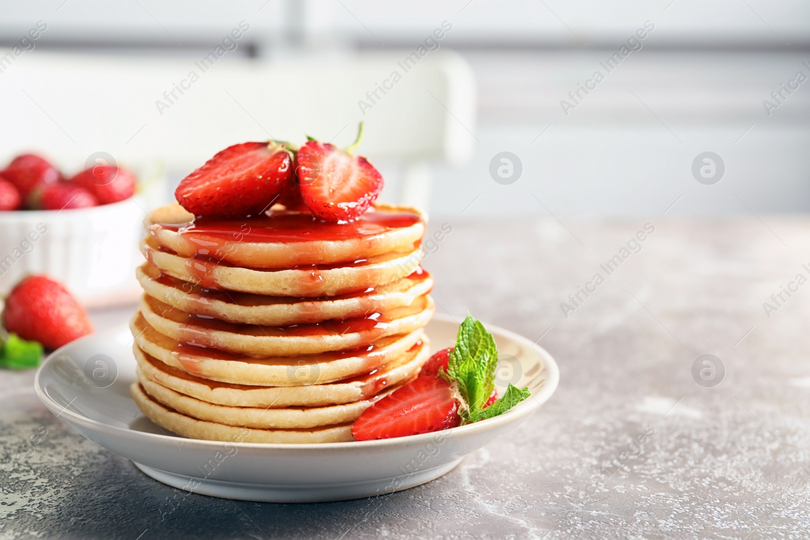 Photo of Plate with pancakes and berries on table