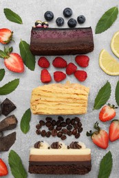 Photo of Flat lay composition with different tasty cakes on light grey table