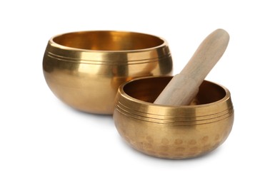 Tibetan singing bowls and wooden mallet on white background