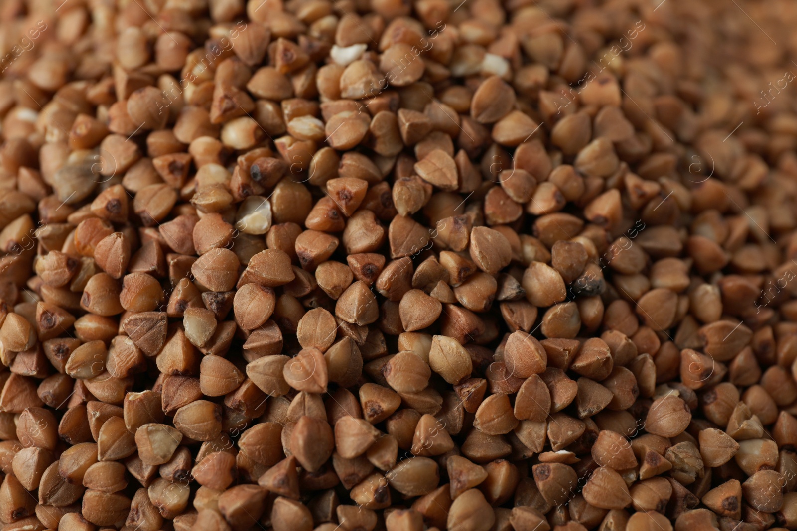 Photo of Uncooked buckwheat as background, closeup. Organic wholesome product