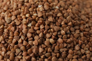 Uncooked buckwheat as background, closeup. Organic wholesome product