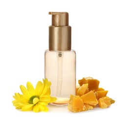 Bottle of cosmetic product, natural beeswax and flower on white background