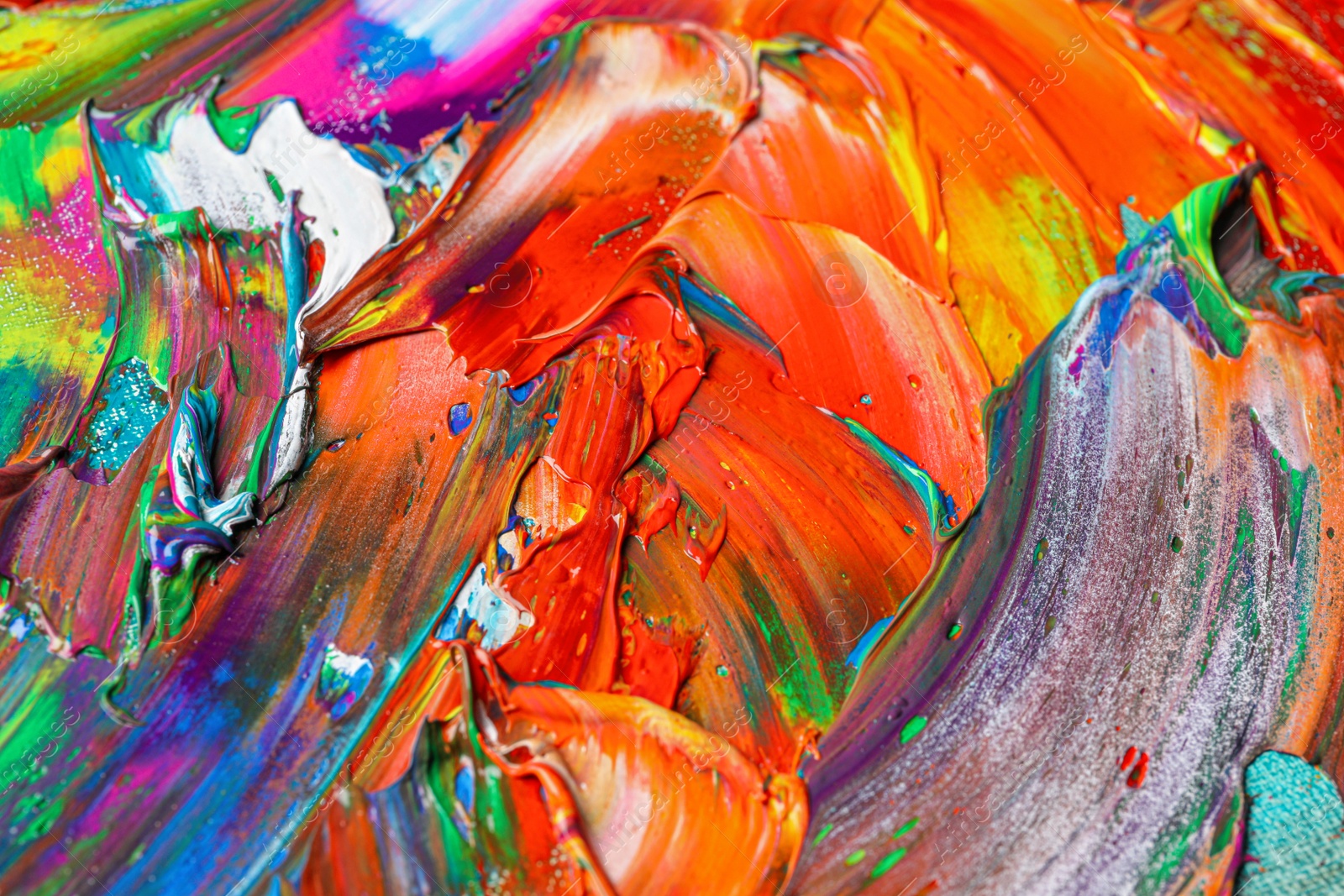 Photo of Strokes of colorful acrylic paints as background, closeup view