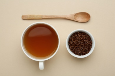 Buckwheat tea and granules on beige background, flat lay