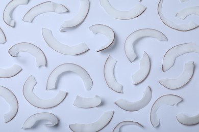 Photo of Fresh coconut flakes on white background, top view