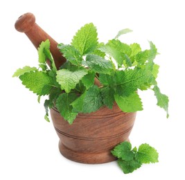 Photo of Wooden mortar with pestle and fresh green lemon balm leaves isolated on white