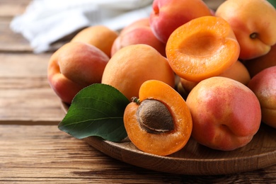 Delicious fresh ripe apricots on wooden table, closeup