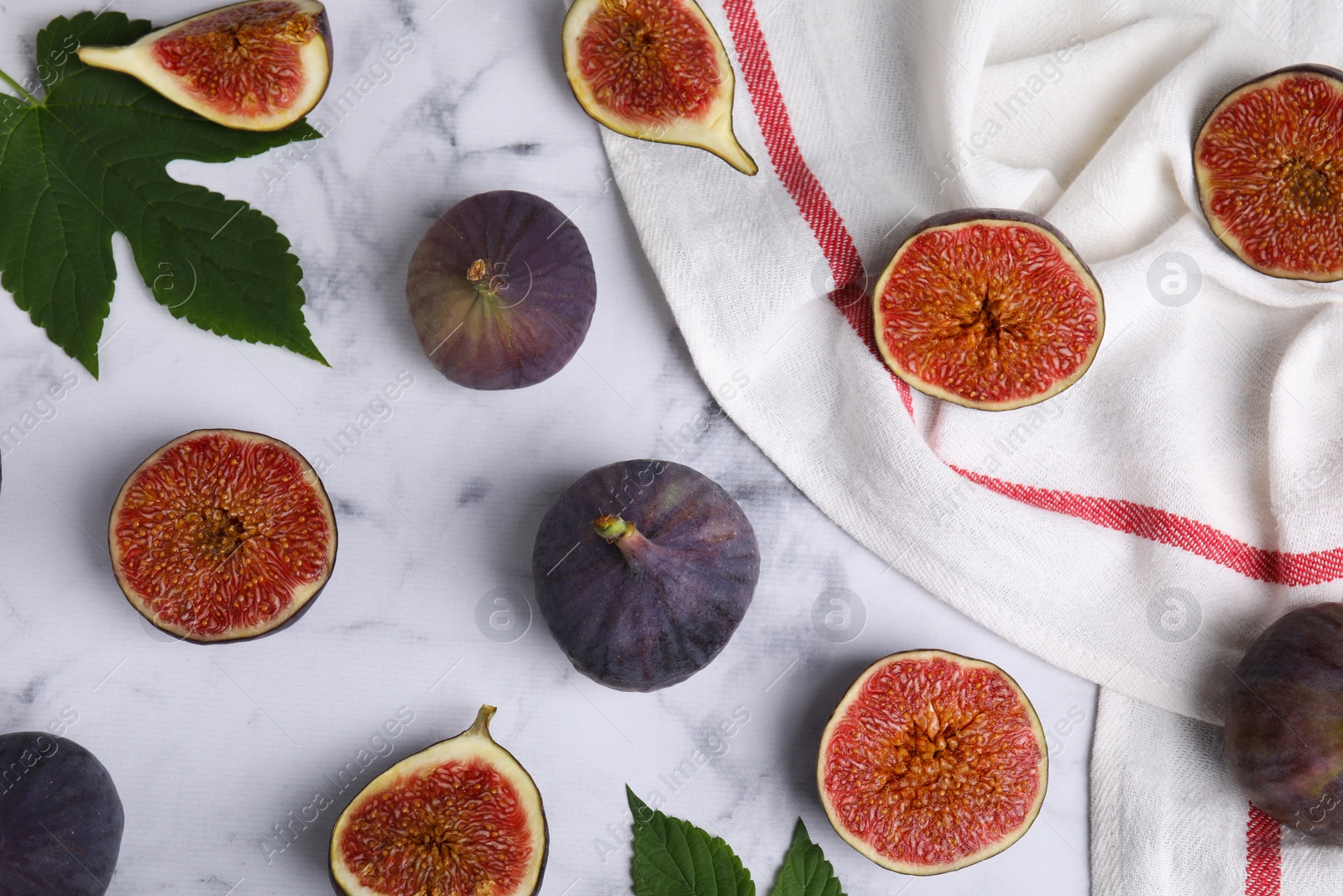 Photo of Fresh ripe purple figs on white marble table, flat lay