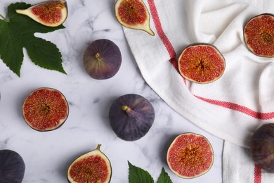 Photo of Fresh ripe purple figs on white marble table, flat lay