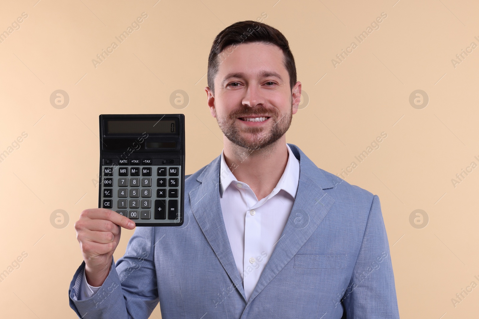 Photo of Happy accountant with calculator on beige background