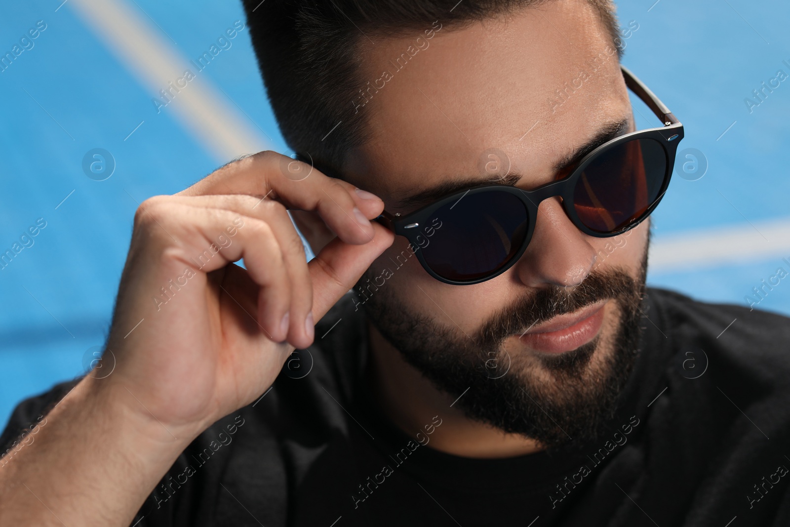 Photo of Handsome man in sunglasses outdoors on sunny day, closeup