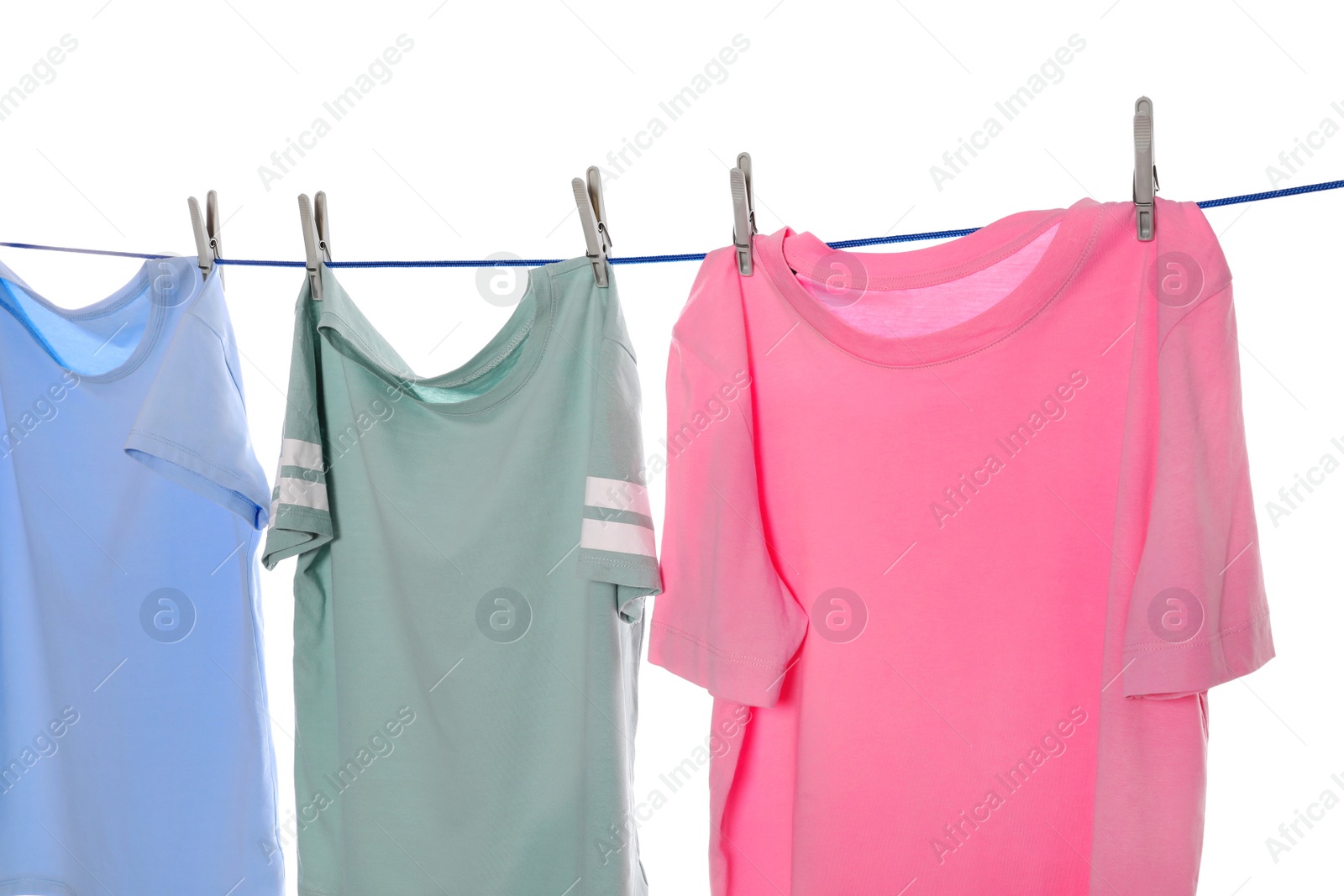 Photo of Different clothes drying on washing line against white background