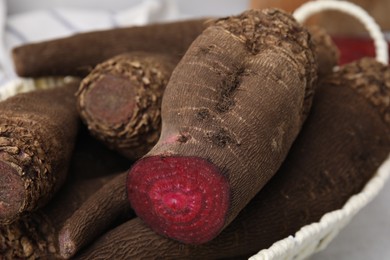 Whole and cut red beets in basket, closeup