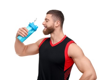 Young man with muscular body holding shaker of protein on white background