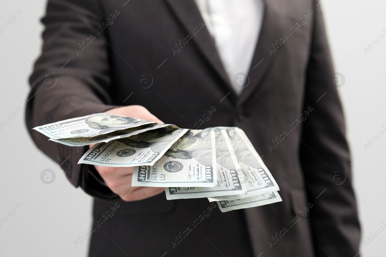 Photo of Man holding money on white background, closeup. Currency exchange